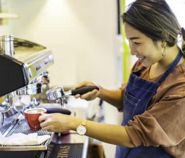 Barista preparing coffee in café. Automated and Manual Coffee Machines