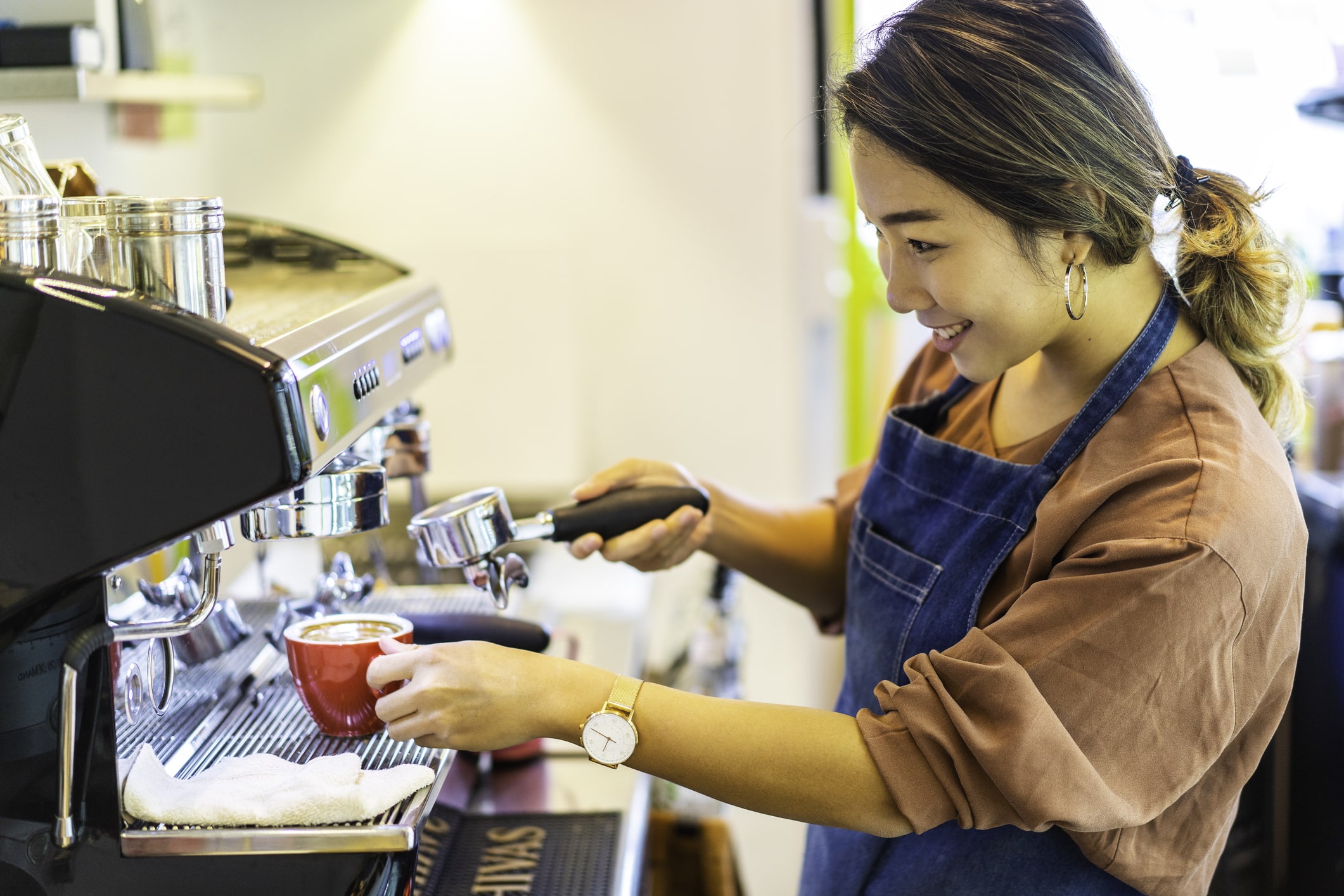 Barista preparing coffee in café. Automated and Manual Coffee Machines